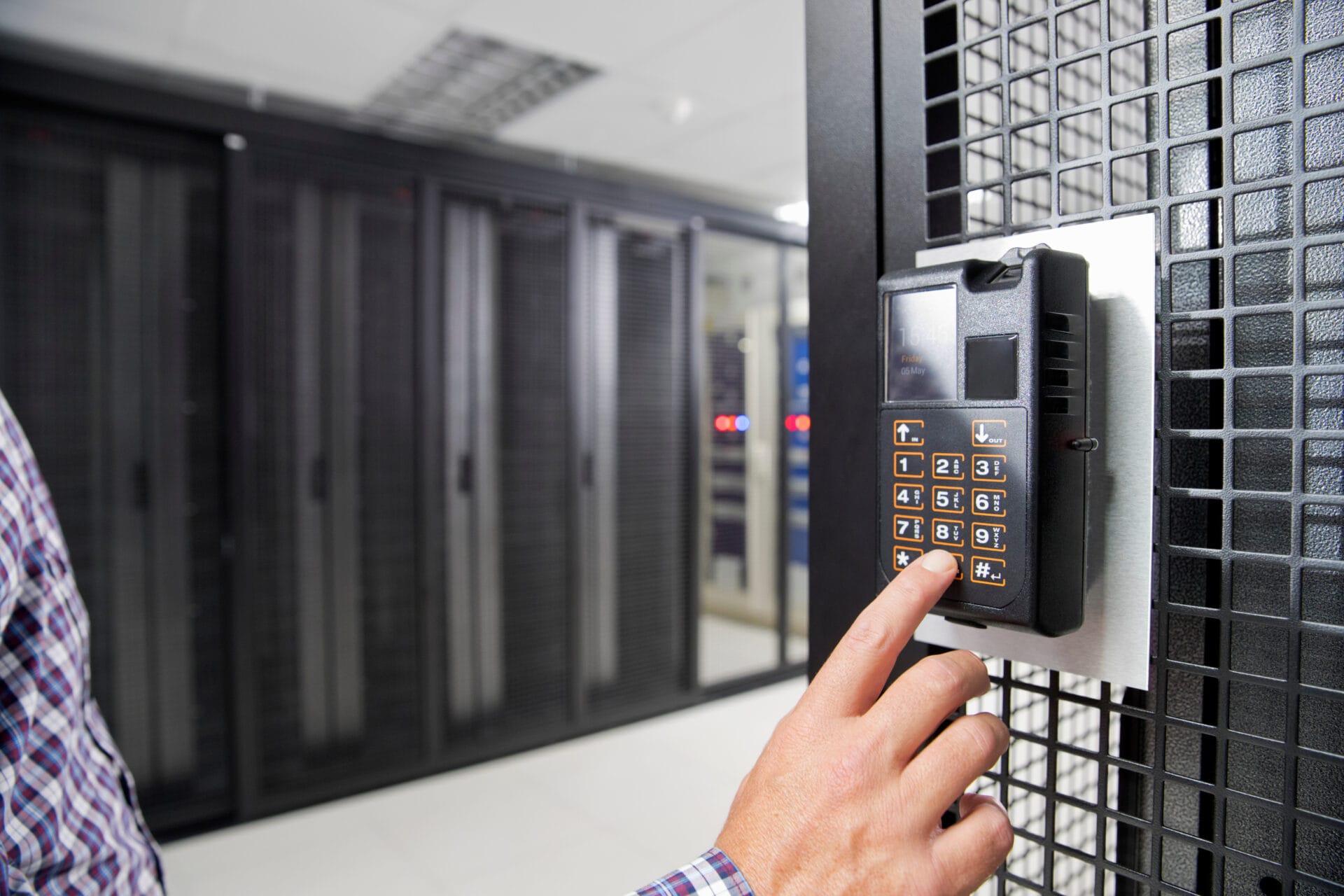 Technician installing a CCTV and security system in a server cabinet